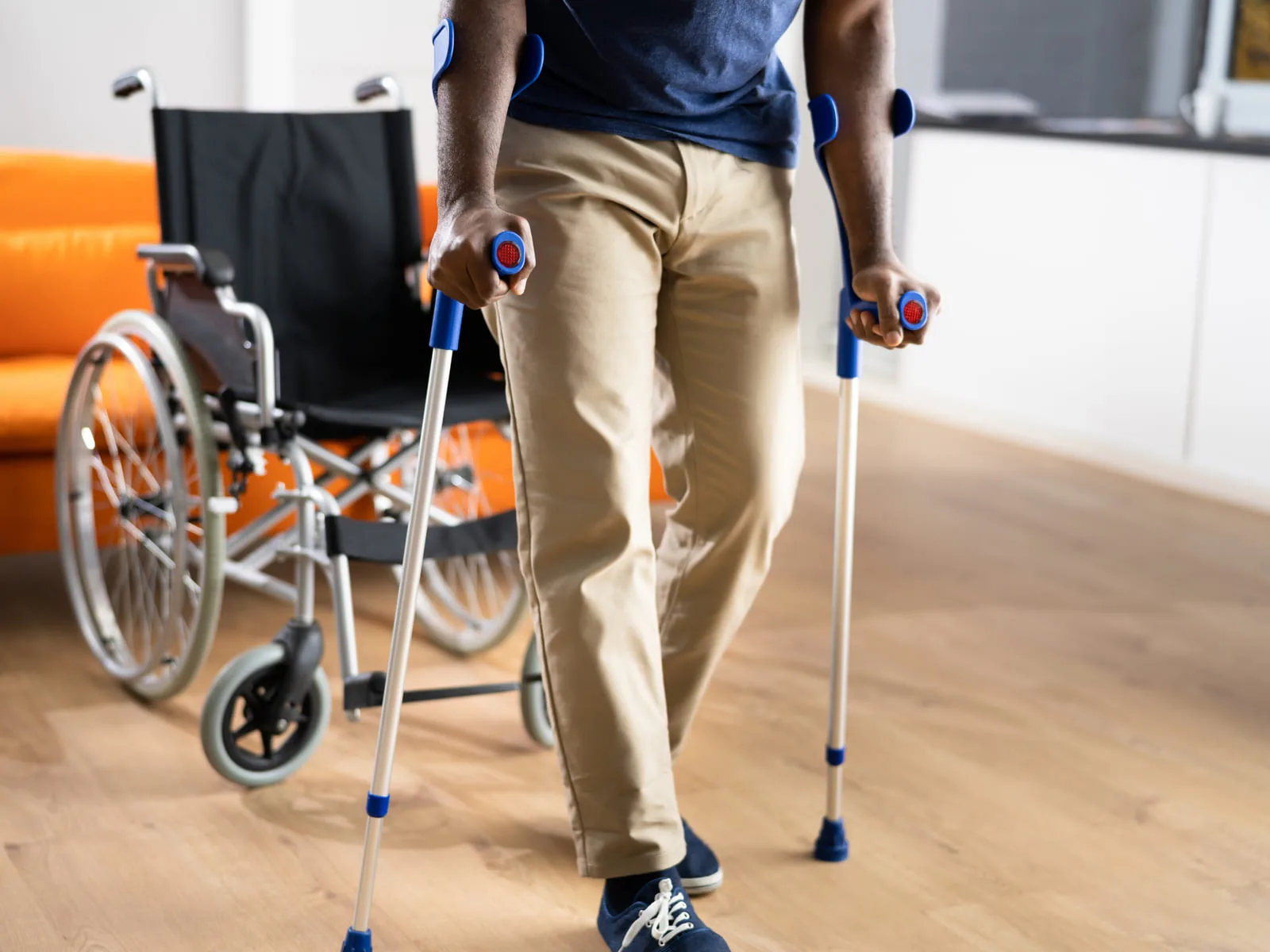 Crutches and a wheelchair set up in a living room