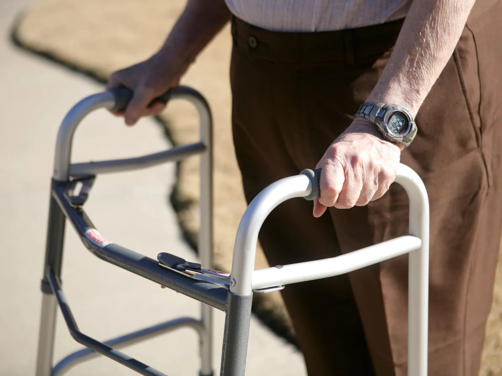 A client steadying themselves on a walker